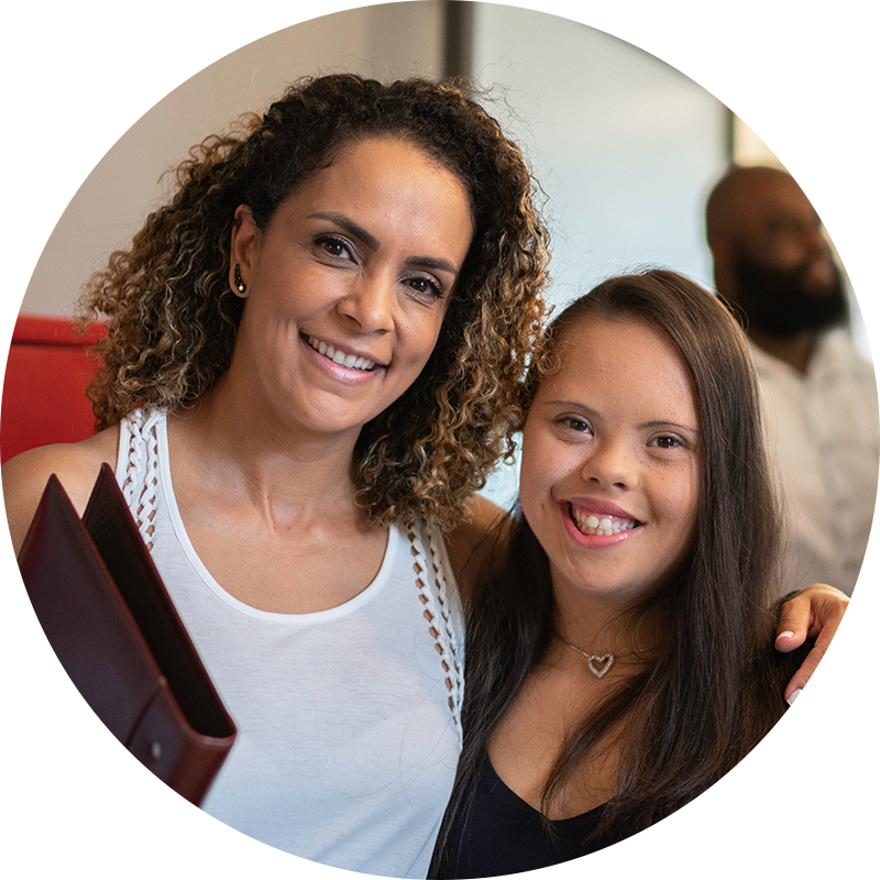 Image of two women smiling, one has Down Syndrome